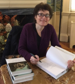 Photograph of Margaret Oppenheimer signing books at the Morris-Jumel Mansion, November 1, 2015.